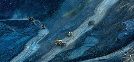 Mining trucks coming down blue road