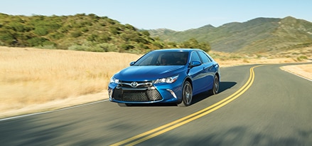Blue Toyota on road