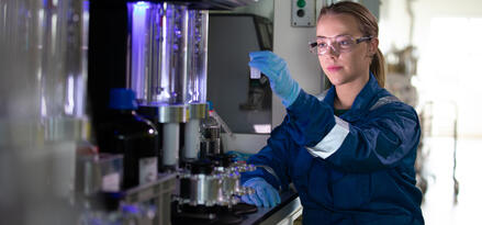 Mobil engineer looking at a lubricant sample