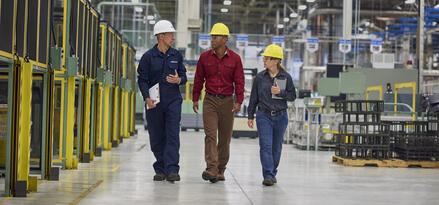 Mobil engineer walking around plant with sales engineers