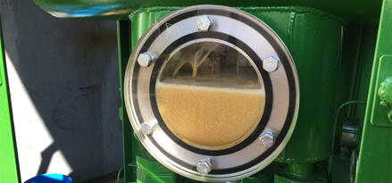 Dehydrator window showing desiccant material inside an industrial dehydration system