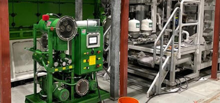 Industrial vacuum dehydrator unit installed in a processing facility for removing moisture and contaminants from industrial fluids